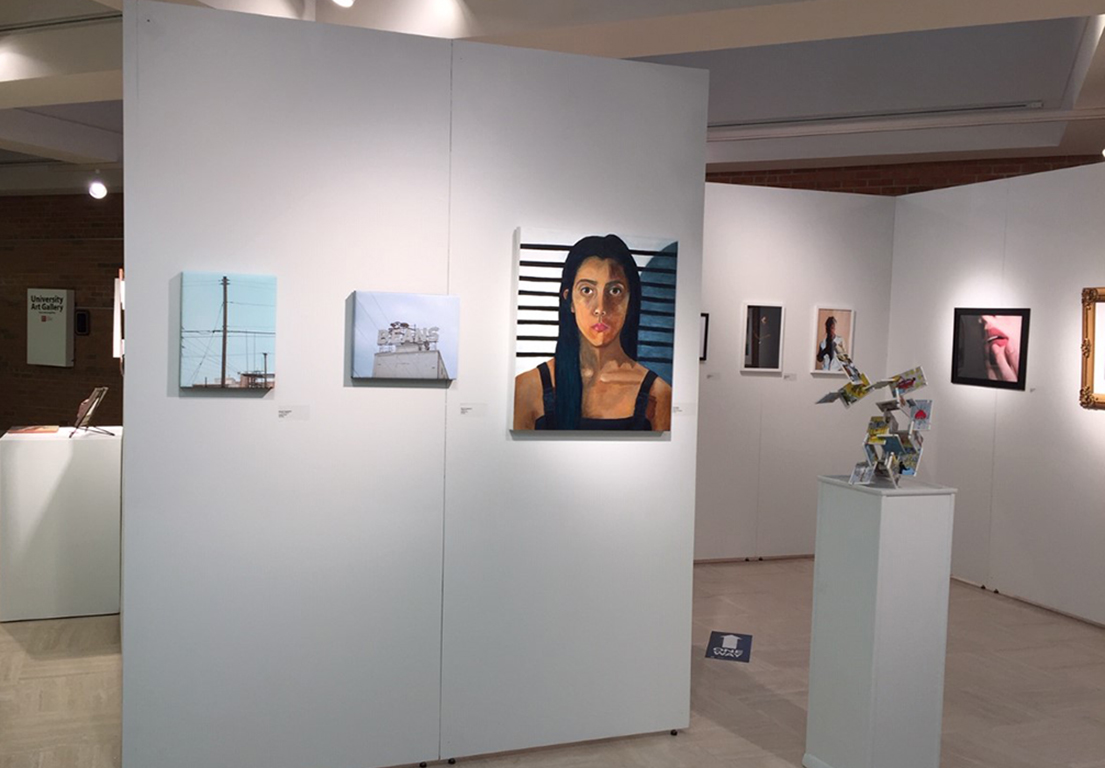 first wall of the exhibition featuring painting and photographs